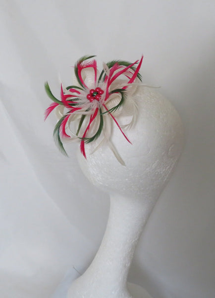 feather fascinator headpiece which sits on the side of the head in ivory with pink and green short curly feathers