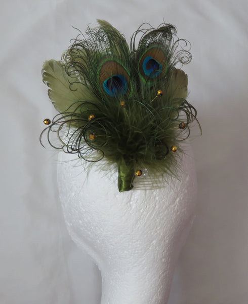 Peacock feather hair clip on a mannequin head with a white background