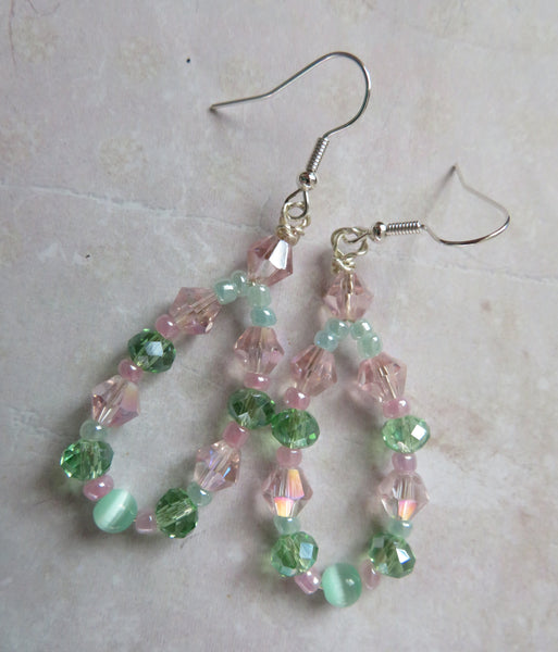 Beaded earrings with pink and green beads on a light background