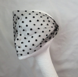 a soft and sheer looking black veil for a bride in a soft spotted tulle netting fabric the spots are about 6mm in size narrow so that it just covers the eyes with two black or coloured hair grips or kirbi grips on either end to fix in the hair at the side