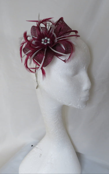 Handmade plum burgundy sinamay loop fascinator with silver-grey feathers, tulle ruffle & pearl accents. Perfect for weddings, parties & special occasions.