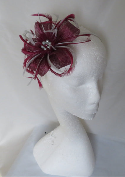 Handmade plum burgundy sinamay loop fascinator with silver-grey feathers, tulle ruffle & pearl accents. Perfect for weddings, parties & special occasions.