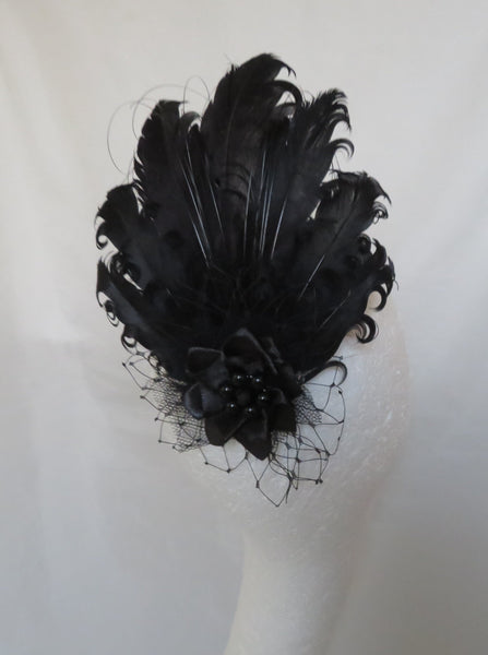 Black feathered hair accessory on a white background