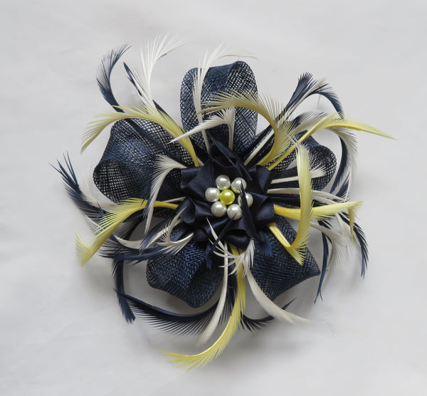 Decorative hair clip with feathers and flowers on a light gray background