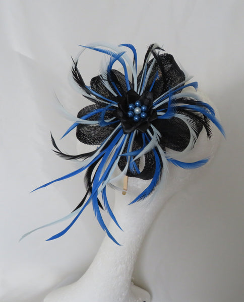 Black and blue feathered hair accessory on a mannequin head against a white background
