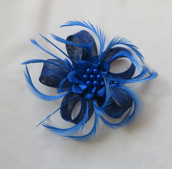 Blue feathered flower accessory on a white background