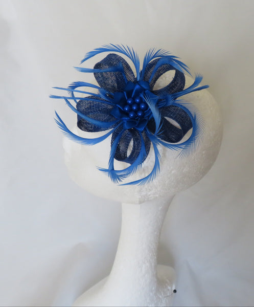 Blue feathered hair accessory on a white mannequin head