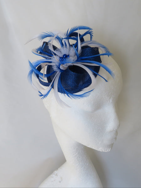 Blue feathered headpiece on a mannequin head against a white background
