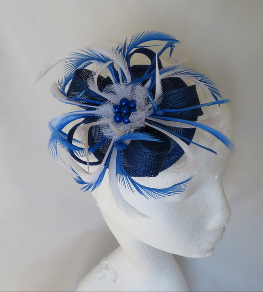 Blue and white feathered headpiece on a mannequin head against a white background
