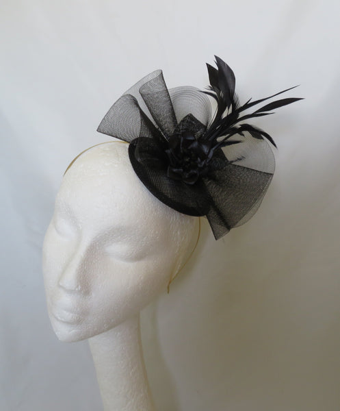 Black and gray decorative headband on a mannequin head against a white background