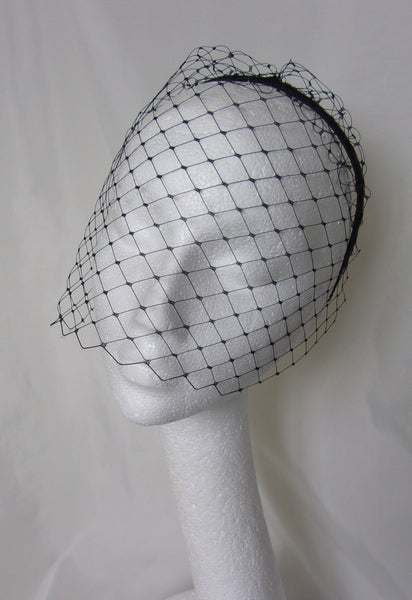 Black Short Birdcage Blusher Merry Widow for a bride or a funeral on a black satin headband with larger holed veiling